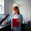 Pekerja melakukan scan dokumen